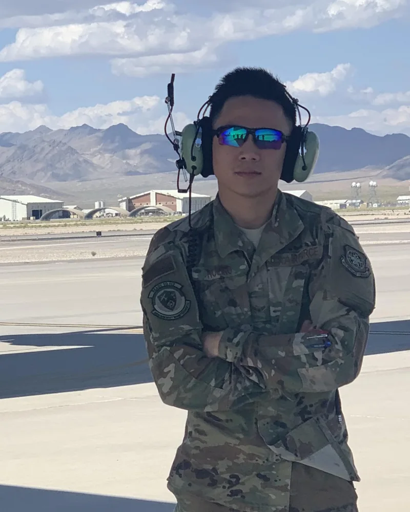 Timothy Molino in uniform and hearing protection on an airfield during his U.S. Air Force service
